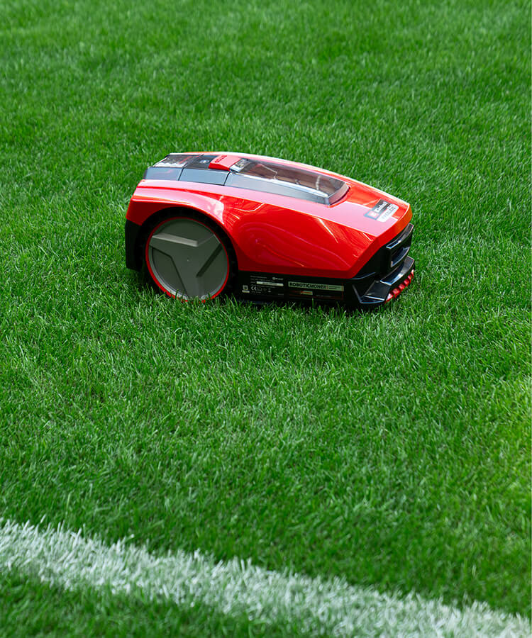 robotic lawn mower mows the football lawn