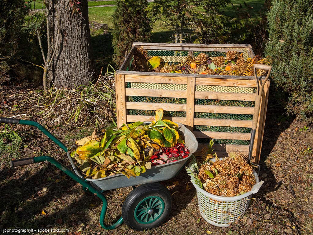 A compost filled with autumn leaves, kitchen scraps and garden waste.