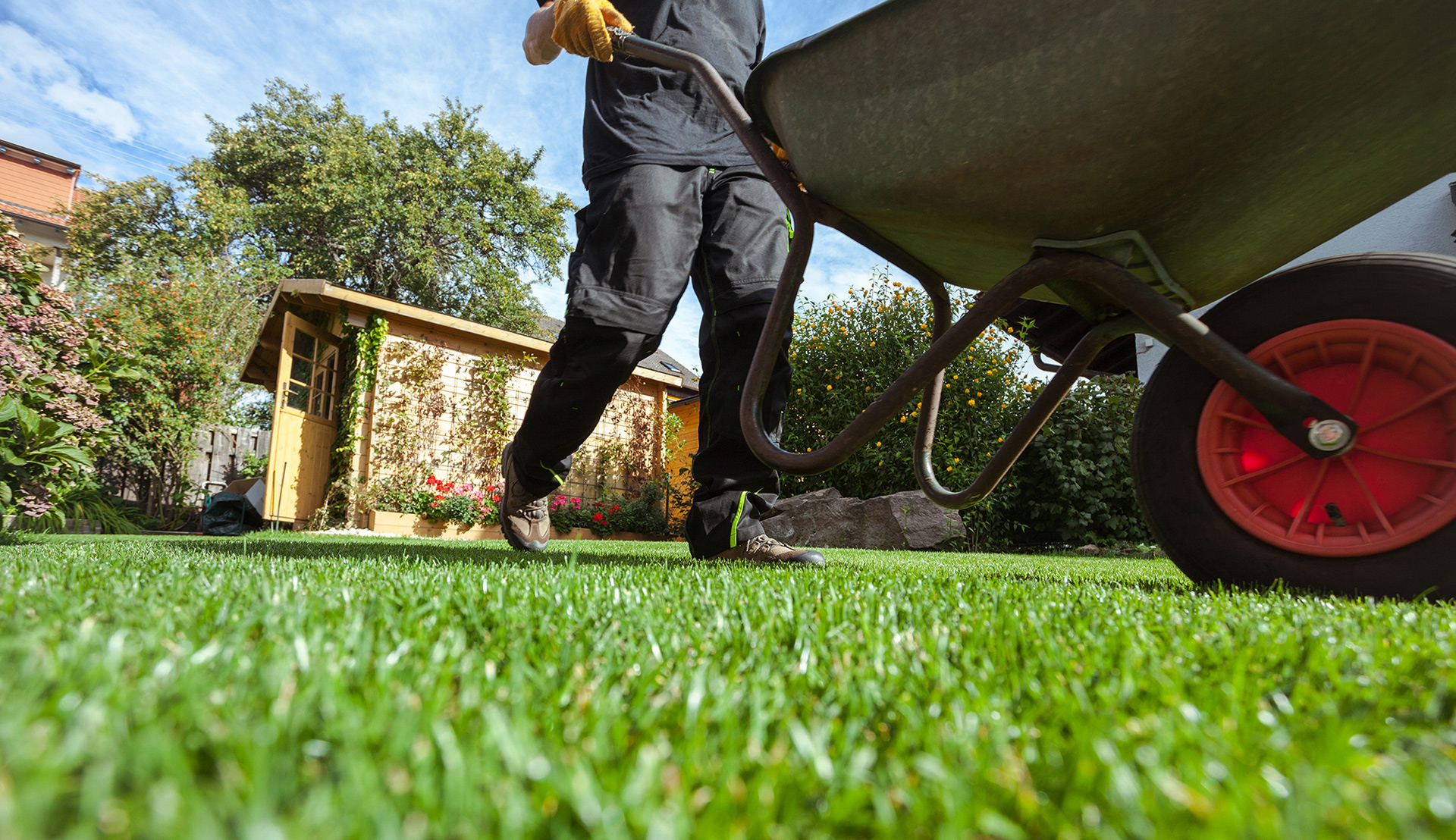 a man pushes a wheelbarrow